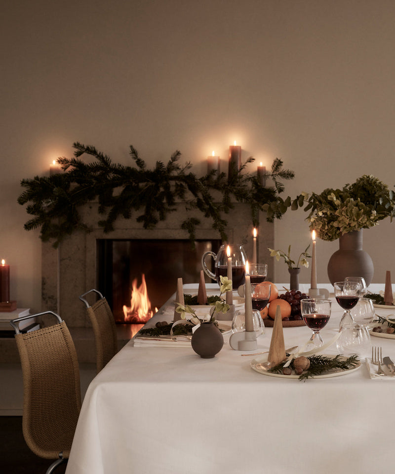A Christmas scene with the table set and the firelit