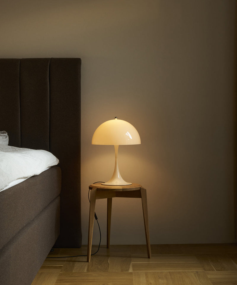 Panthella 320 table lamp in opal on a bedside table