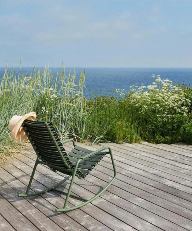 HOUE ReCLIPS garden rocking chair on decking looking over water