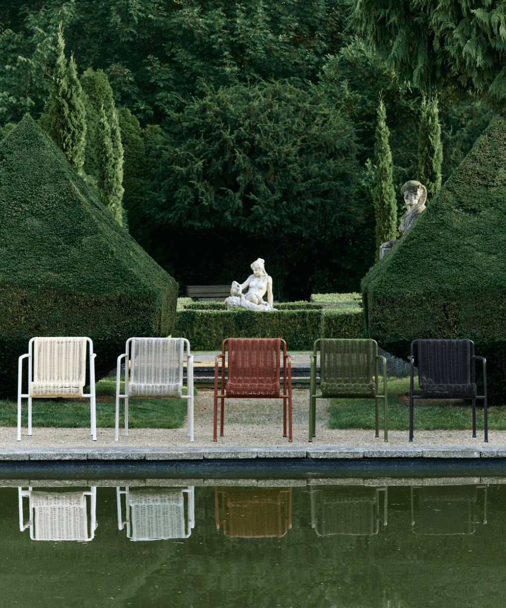 Each colour of HAY Palissade Cord Garden Chair lined up together in a stately garden